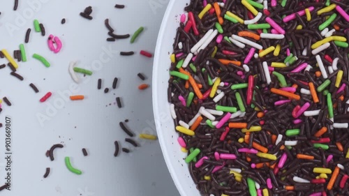 top view close up of chocolate sprinkles in spinning white plate