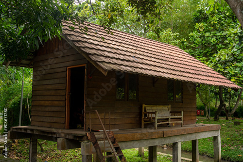 Traditional Wooden Stilt House by the River in Indonesia