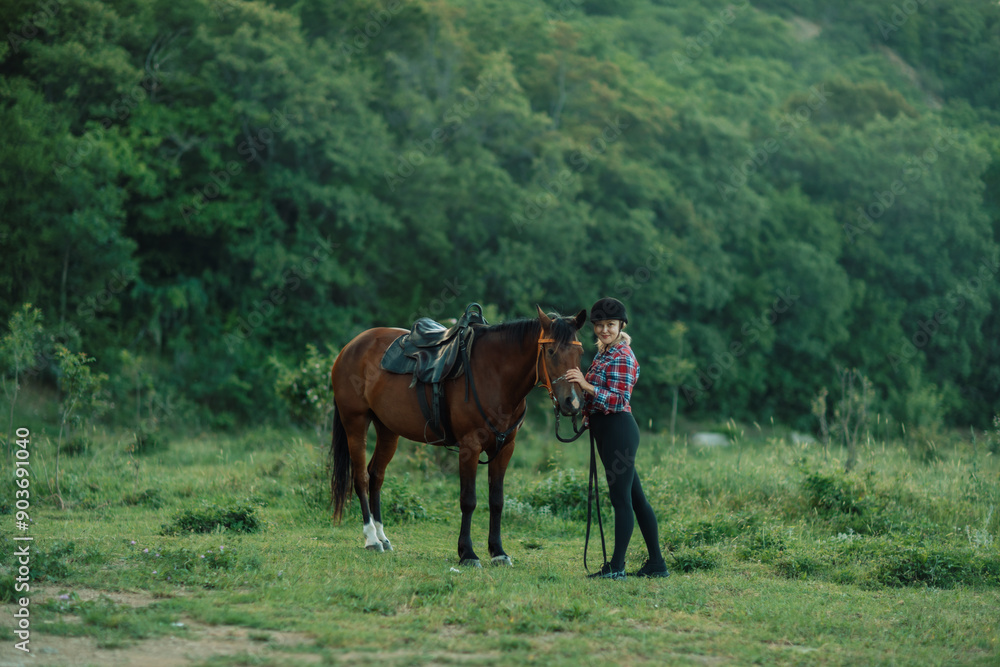 Happy blonde with horse in forest. Woman and a horse walking through the field during the day. Dressed in a plaid shirt and black leggings. Happy blonde with horse in forest. Woman and a horse walking through the field during the day. Dressed in a plaid shirt and black leggings.