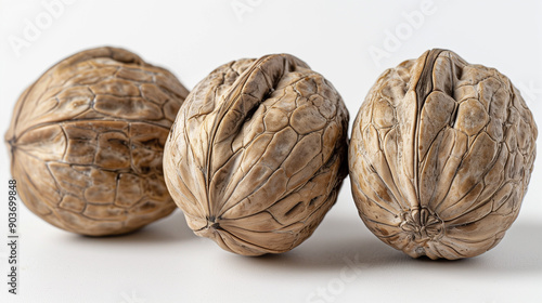 Walnuts. hree whole walnuts on a plain background. photo