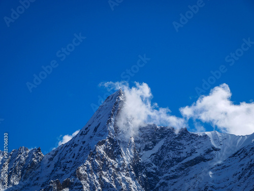 snow covered mountains in the clouds