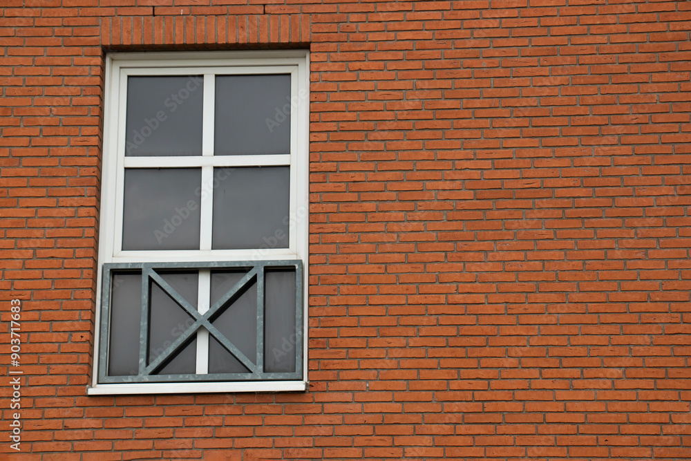 Modern beautiful white frame window on a brick wall of a house Modern beautiful white frame window on a brick wall of a house