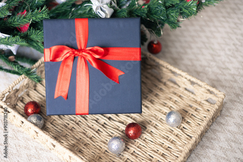 Black gift box with a red bow