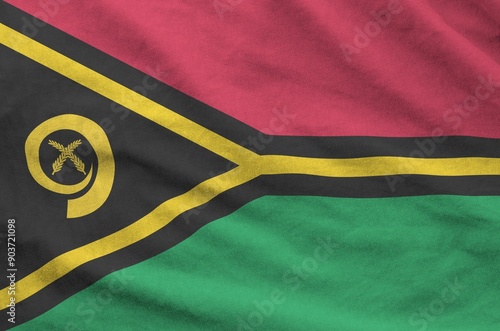 Vanuatu flag depicted on folded wavy fabric of old cloth close up photo