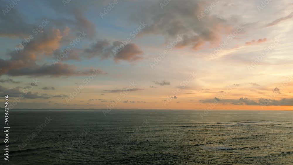 The sunset paints the sky over the tranquil ocean with a warm afterglow The sunset paints the sky over the tranquil ocean with a warm afterglow