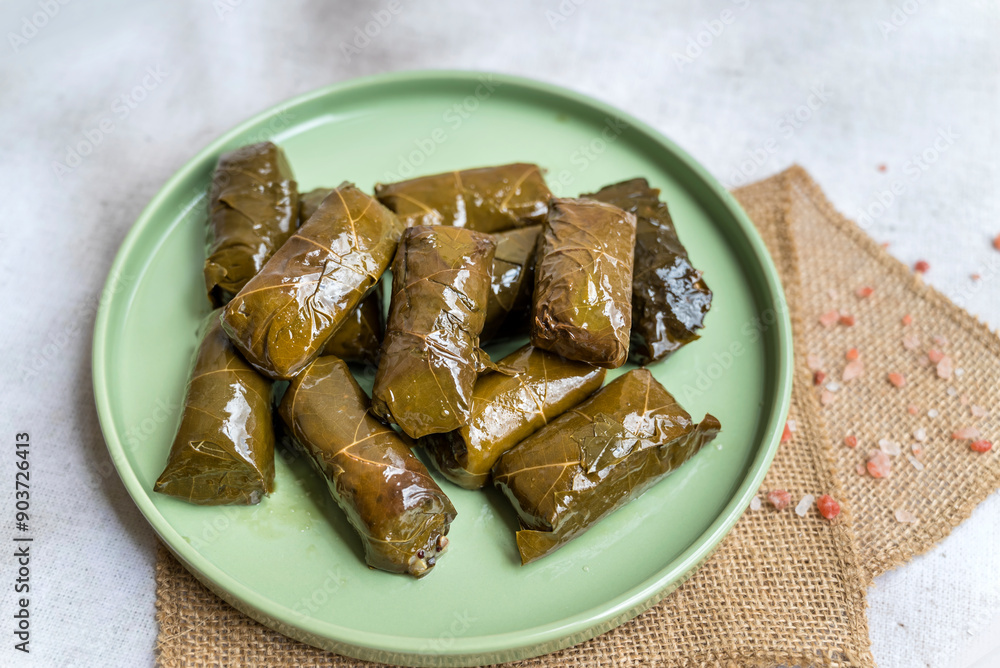 Fototapeta premium Delicious dolmades , grape leaves stuffed with rice .Greek cuisine 