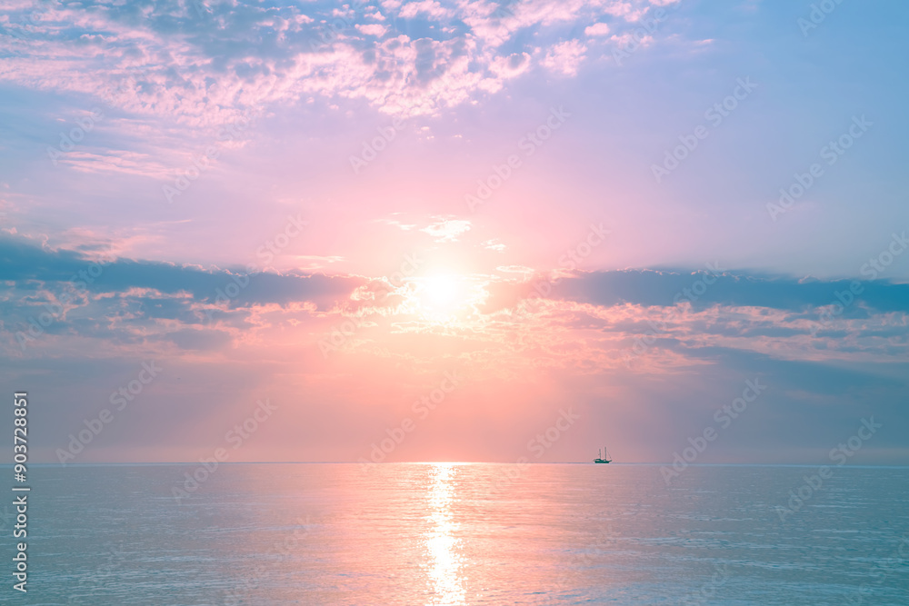 Fototapeta premium Beautiful gentle and delicate pink sunrise on the sea, sky with clouds, natural delicate background