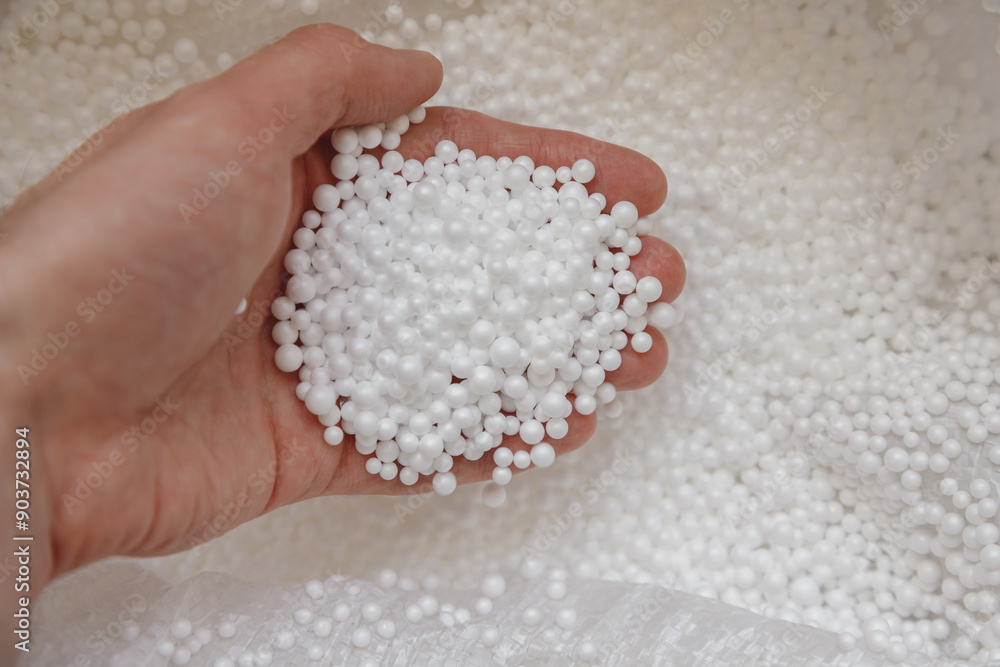 Polystyrene balls in hand. Packaging of fragile goods, filling for chair bags and pillows