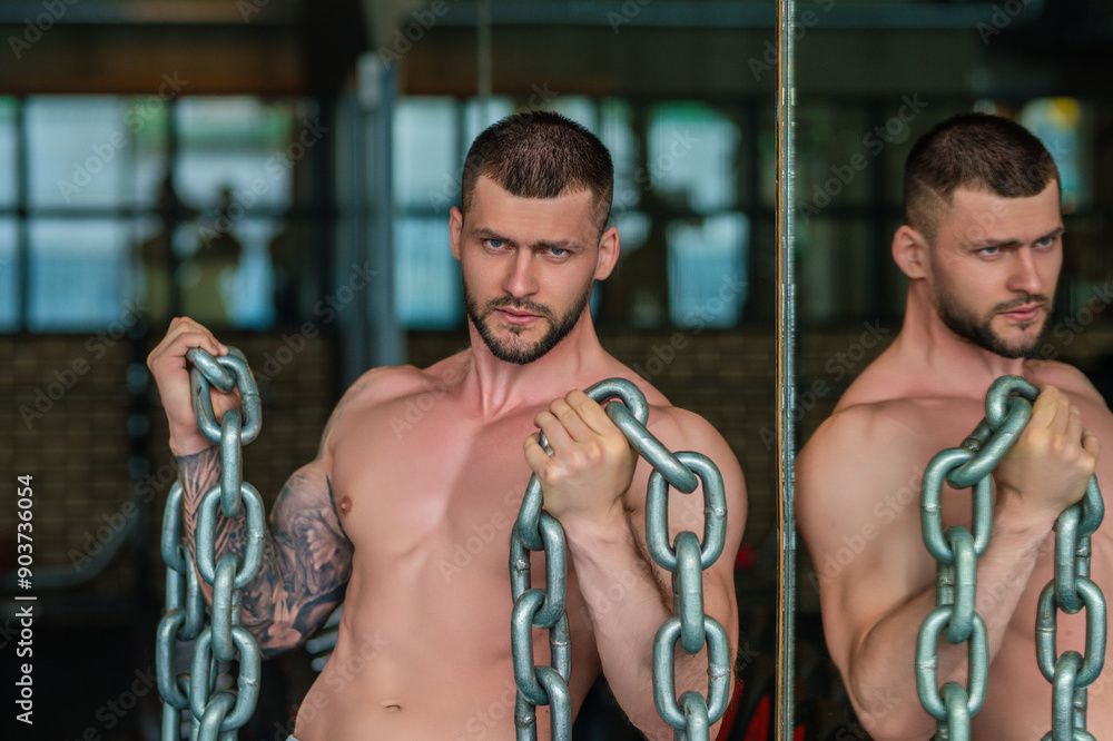 Obraz premium Portrait of handsome sporty man with muscular body doing weight lifting. Guy workout at gym. Fitness trainer, sport instructor, sporty man, fit model sportsman workout. Power athletic guy bodybuilder.