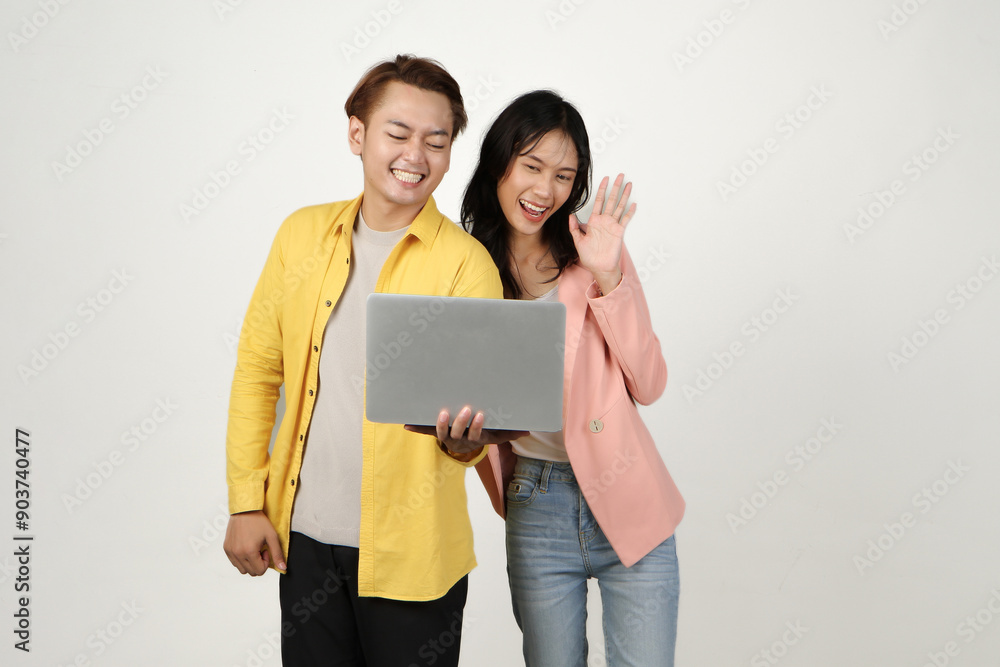 portrait of happy asian Indonesian couple holding laptop computer while video conference call on isolated background portrait of happy asian Indonesian couple holding laptop computer while video conference call on isolated background