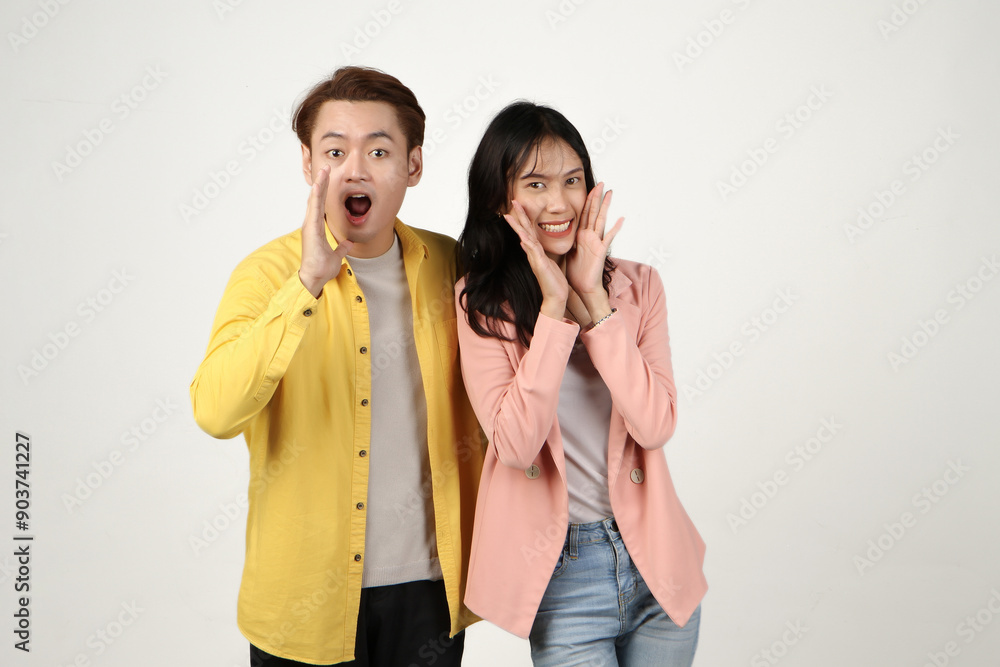 portrait of happy asian Indonesian couple shouting outloud with cupping hand on isolated background. portrait of happy asian Indonesian couple shouting outloud with cupping hand on isolated background.