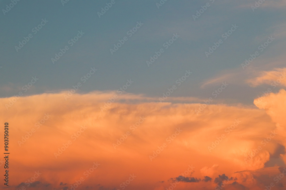 Sunset sky with orange clouds. View of orange clouds in the sky background. orange clouds illuminated by the setting sun Sunset sky with orange clouds. View of orange clouds in the sky background. orange clouds illuminated by the setting sun