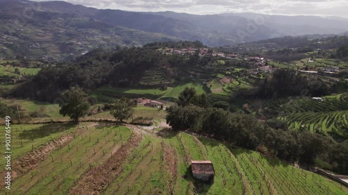 Drone rapidly approaching a small farm on a hillside. photo