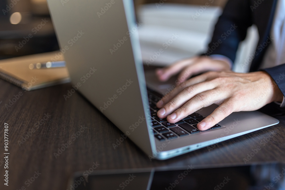 Closeup of businessman hands typing on keyboard on laptop computer Closeup of businessman hands typing on keyboard on laptop computer