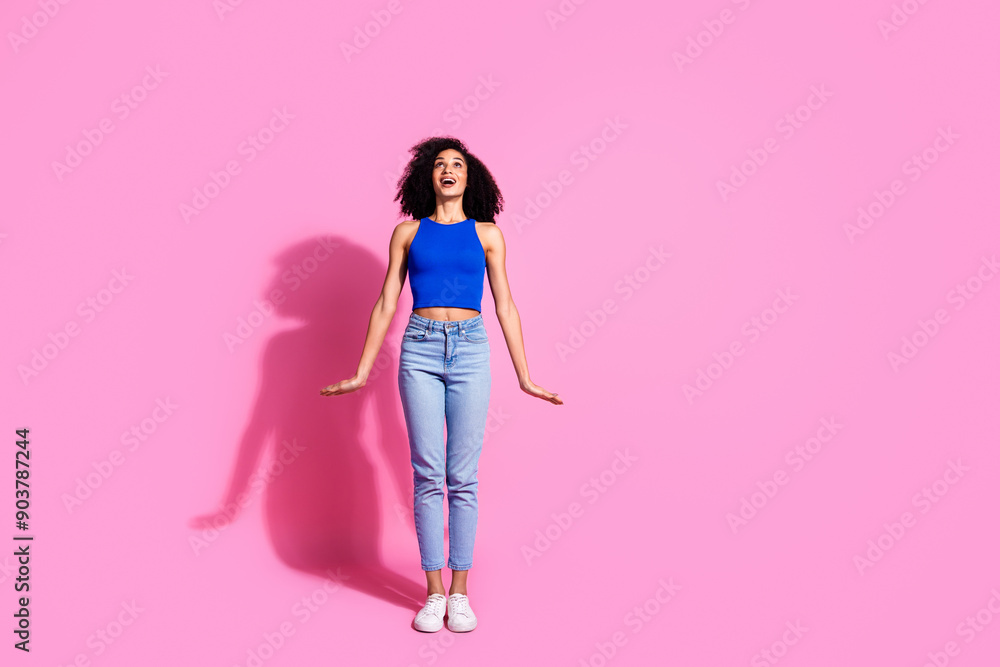 Photo of surprised positive girl look up empty space isolated pastel color background Photo of surprised positive girl look up empty space isolated pastel color background
