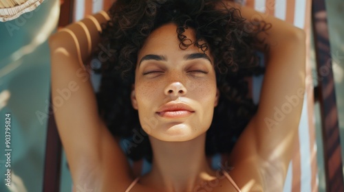 A person enjoying a sunny day at the beach, great for travel and leisure photos #903795824