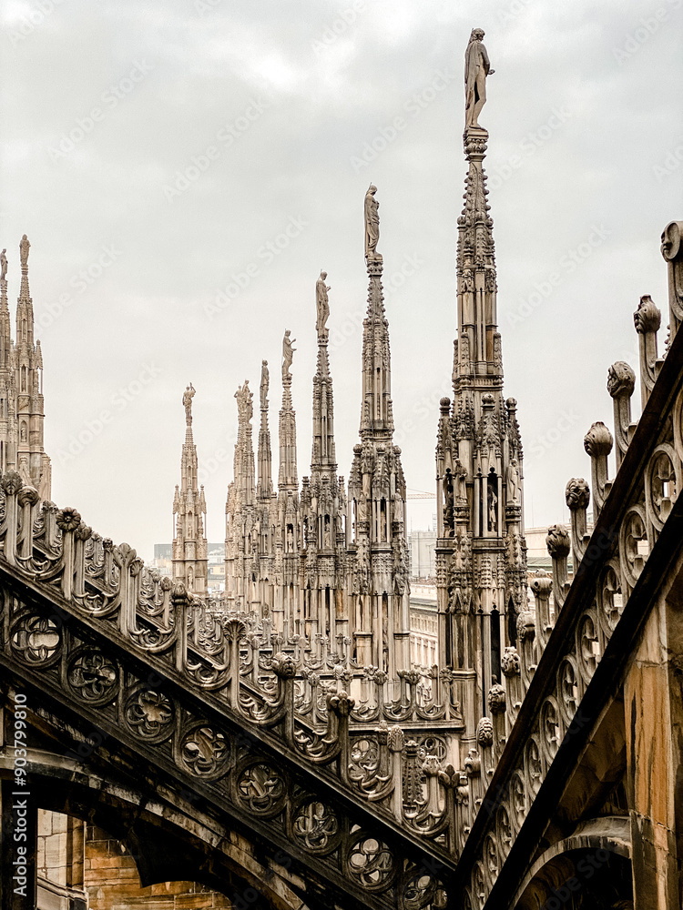 Top view from the roof of Duomo di Milano Cathedral with marble statues to the city and the Royal Palace Palazzo Reale on Piazza del Duomo square Top view from the roof of Duomo di Milano Cathedral with marble statues to the city and the Royal Palace Palazzo Reale on Piazza del Duomo square
