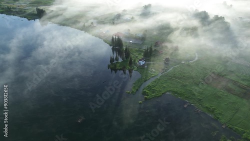 Aerial footage of a tranquil morning in Alahan Panjang, Sumatera Barat, Indonesia. Capturing misty landscapes, lush greenery, and serene beauty from a drone's perspective. photo