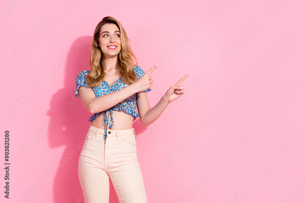 Photo portrait of pretty young girl point look empty space wear trendy blue flower print outfit isolated on pink color background
