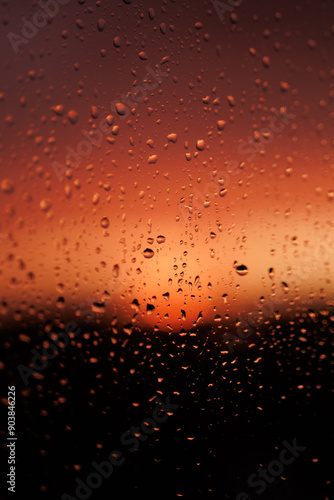 Rain drops on the glass. Drops on the window. Rain at sunset. Rain drops on the window during sunset.