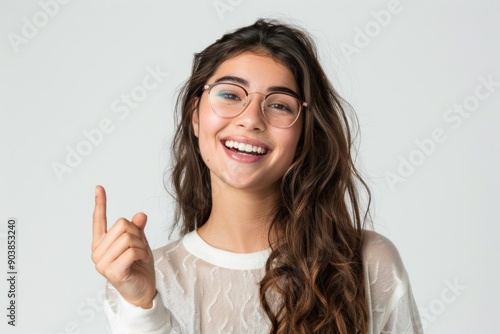 Wallpaper Mural Smiling young woman pointing at something isolated on white color background Torontodigital.ca