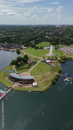 Wide aerial shot of Willen Lake, Milton Keynes, featuring the watersports centre and ferris, Xscape and the city in the background