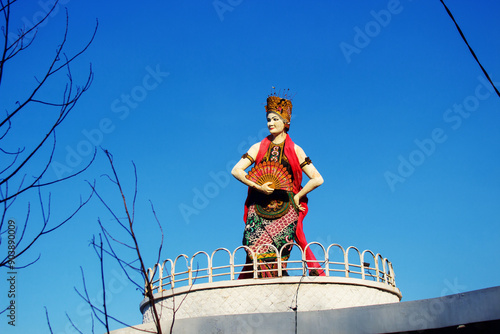 Traditional gandrung dancer statue in elaborate costume photo