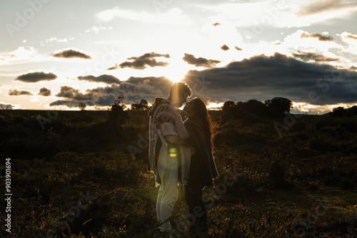 Multiracial Latino couple kissing at sunset in the Ecuadorian Andean plains