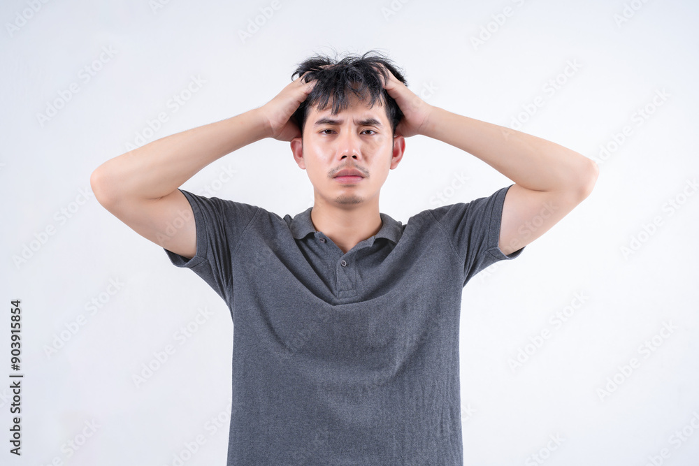 Portrait of handsome Asian man suffering from headache because stress and health problems. Medical and healthcare concept on white background. Portrait of handsome Asian man suffering from headache because stress and health problems. Medical and healthcare concept on white background.