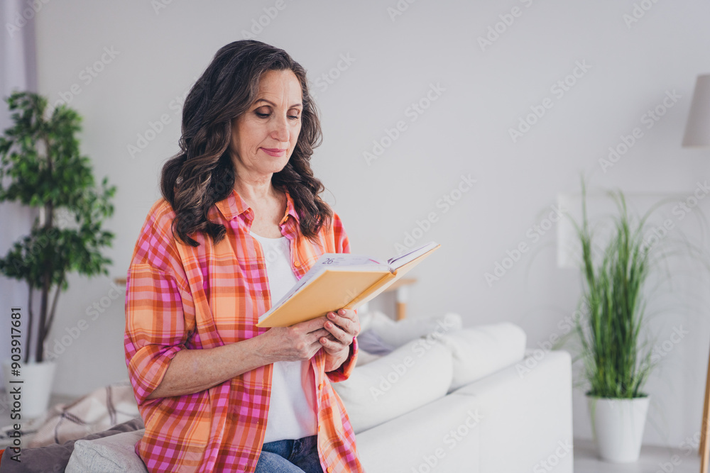 Photo of adorable sweet lady wear plaid shirt reading story smiling indoors room home house