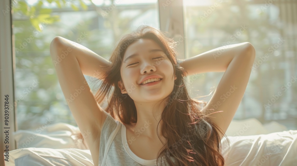 Happy Woman Stretching and Smiling in Bed, Sunlit Room Happy Woman Stretching and Smiling in Bed, Sunlit Room