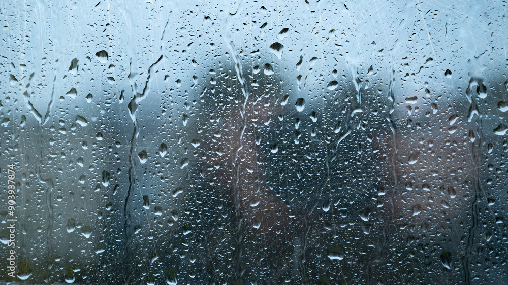 Water drops on glass window with autmn forest background Water drops on glass window with autmn forest background