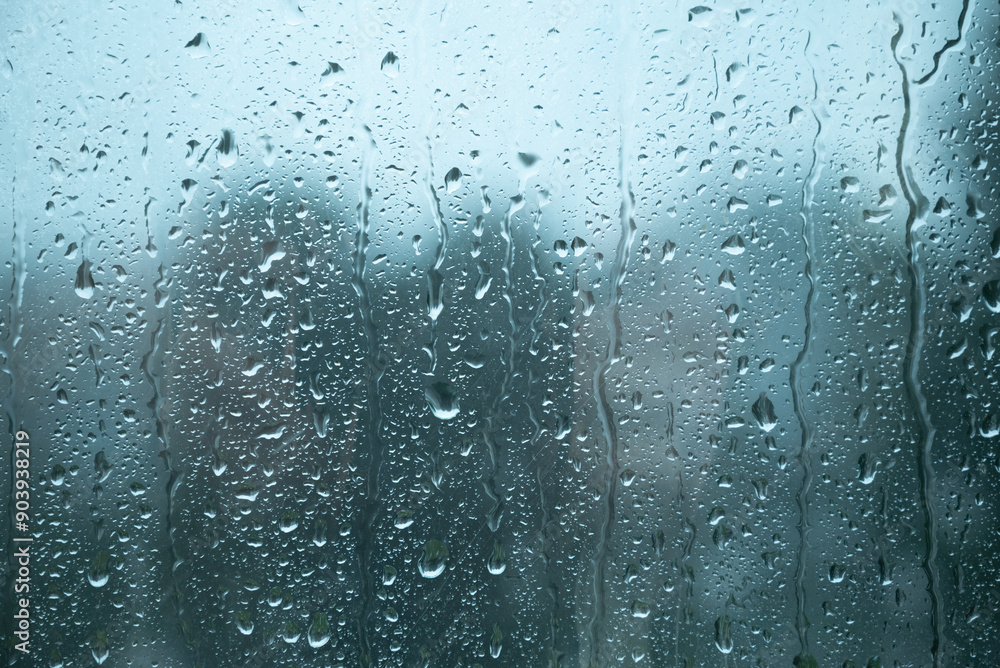 Water drops on glass window with autmn forest background Water drops on glass window with autmn forest background