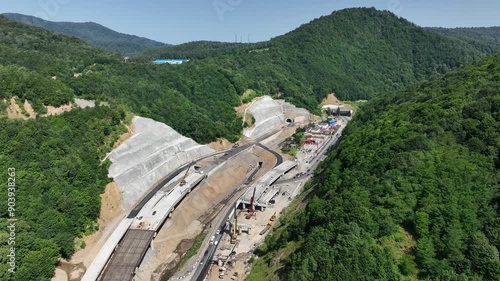 Rikoti, Georgia - July 17 2024: aerial view of cranes and bridge foundation pillars on construction site of new highway road project built by chinese builders in Rikoti bypass photo