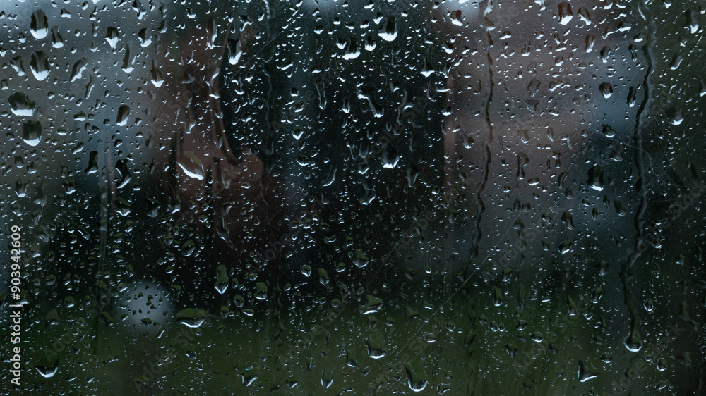 Water drops on glass window with autmn forest background Water drops on glass window with autmn forest background