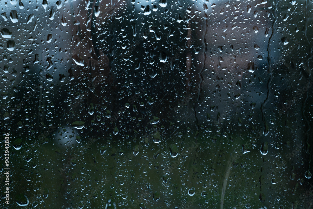Water drops on glass window with autmn forest background Water drops on glass window with autmn forest background