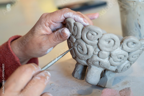 shape clay with hands	