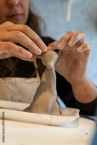 shape clay with hands	 photo