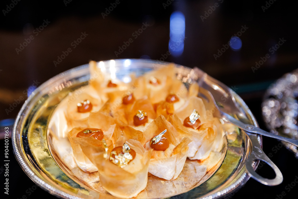 Elegant Appetizer Plate: Savory Bites with Delicate Toppings on Silver Platter