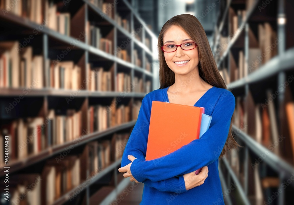 Young woman student in library, preparing for exam. Young woman student in library, preparing for exam.