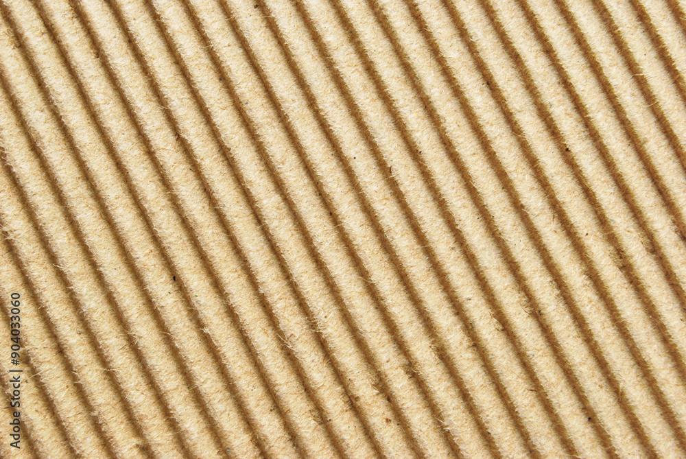 A sheet of brown corrugated cardboard texture as background A sheet of brown corrugated cardboard texture as background