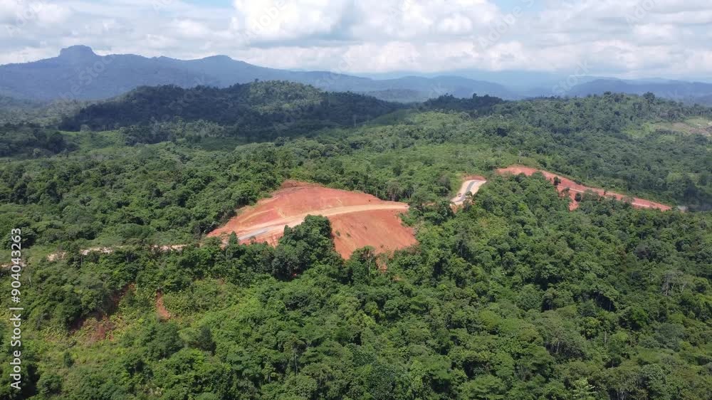 Aerial view of the opening or construction of the alternative road from Batulicin to Banjarbaru, South Kalimantan, surrounded by beautiful mountain views. Aerial view of the opening or construction of the alternative road from Batulicin to Banjarbaru, South Kalimantan, surrounded by beautiful mountain views.