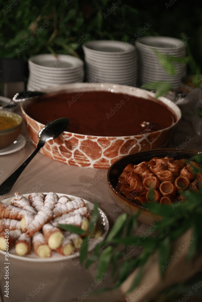 A decadent chocolate fondue served with fresh pastry and fruit, perfect for a party or special occasion A decadent chocolate fondue served with fresh pastry and fruit, perfect for a party or special occasion
