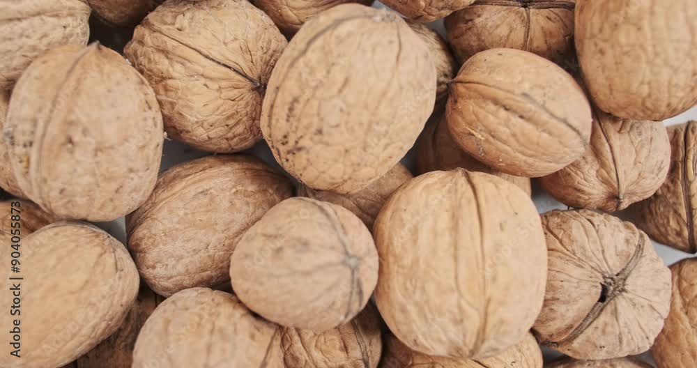 Smooth rotation of wallnuts in shell, top view. Close-up slow motion