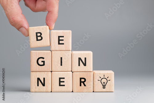 Wall Mural Closeup hand build a small staircase with alphabet wood cubes, Beginner level co