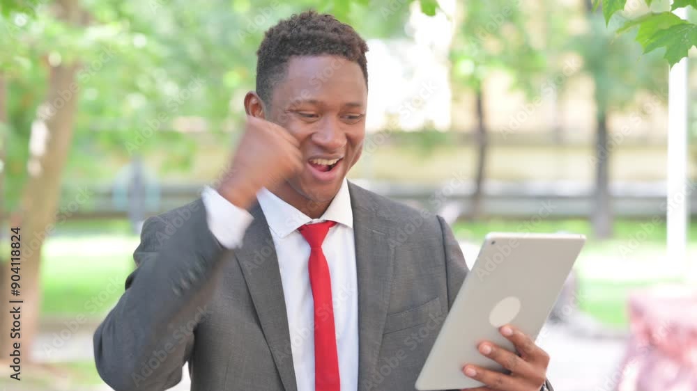 African Businessman Celebrating Success on Tablet Outdoor African Businessman Celebrating Success on Tablet Outdoor