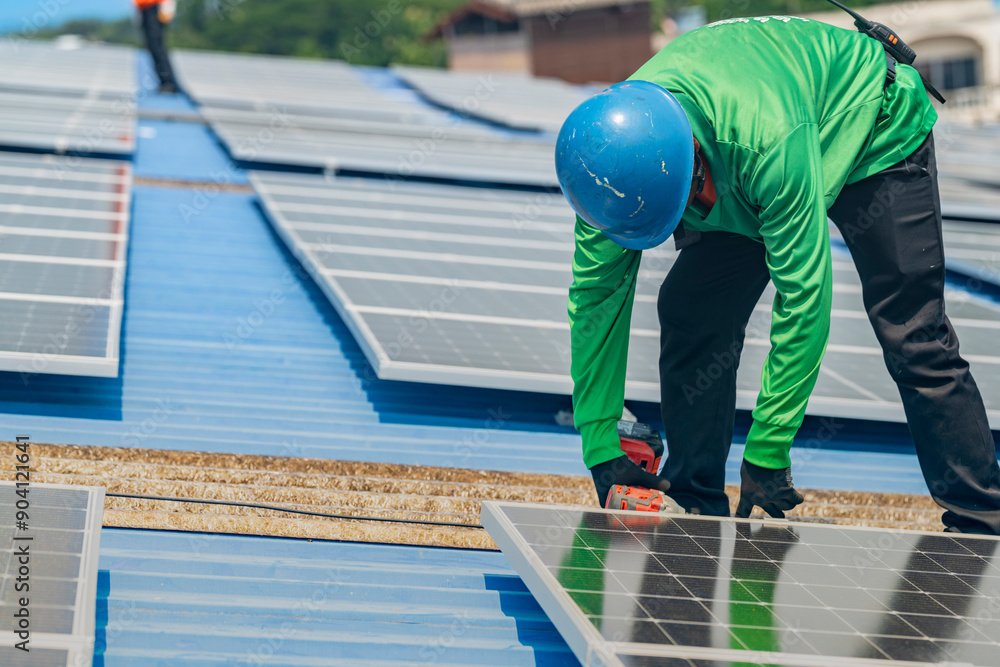 Worker Technicians are working to construct solar panels system on roof. Installing solar photovoltaic panel system. Men technicians walking on roof structure to check photovoltaic solar modules.