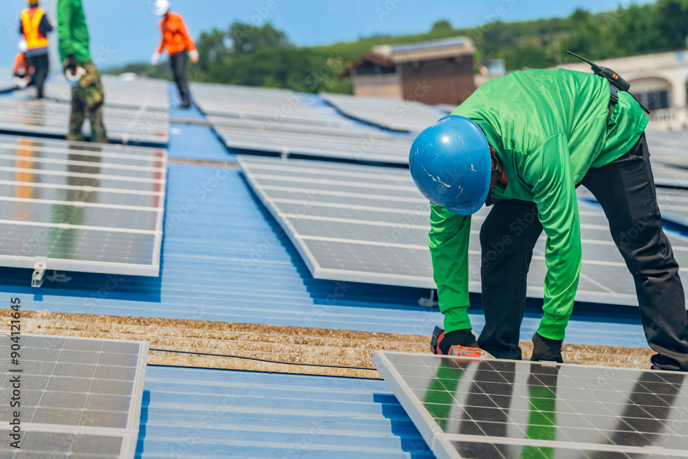 Worker Technicians are working to construct solar panels system on roof. Installing solar photovoltaic panel system. Men technicians walking on roof structure to check photovoltaic solar modules. Worker Technicians are working to construct solar panels system on roof. Installing solar photovoltaic panel system. Men technicians walking on roof structure to check photovoltaic solar modules.