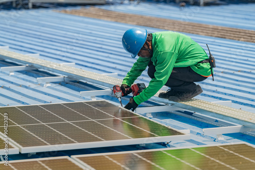 Worker Technicians are working to construct solar panels system on roof. Installing solar photovoltaic panel system. Men technicians walking on roof structure to check photovoltaic solar modules.