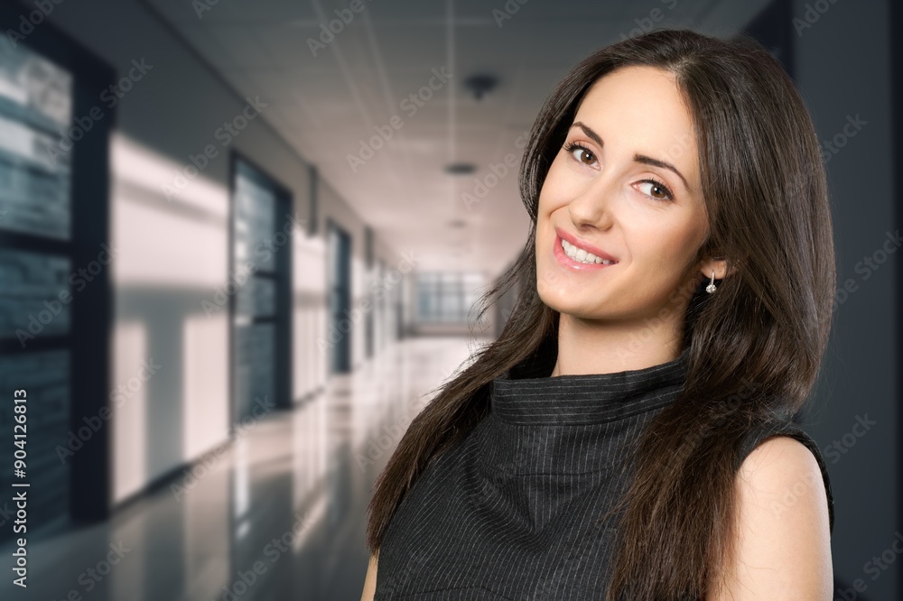 Happy confident professional business woman standing in office Happy confident professional business woman standing in office